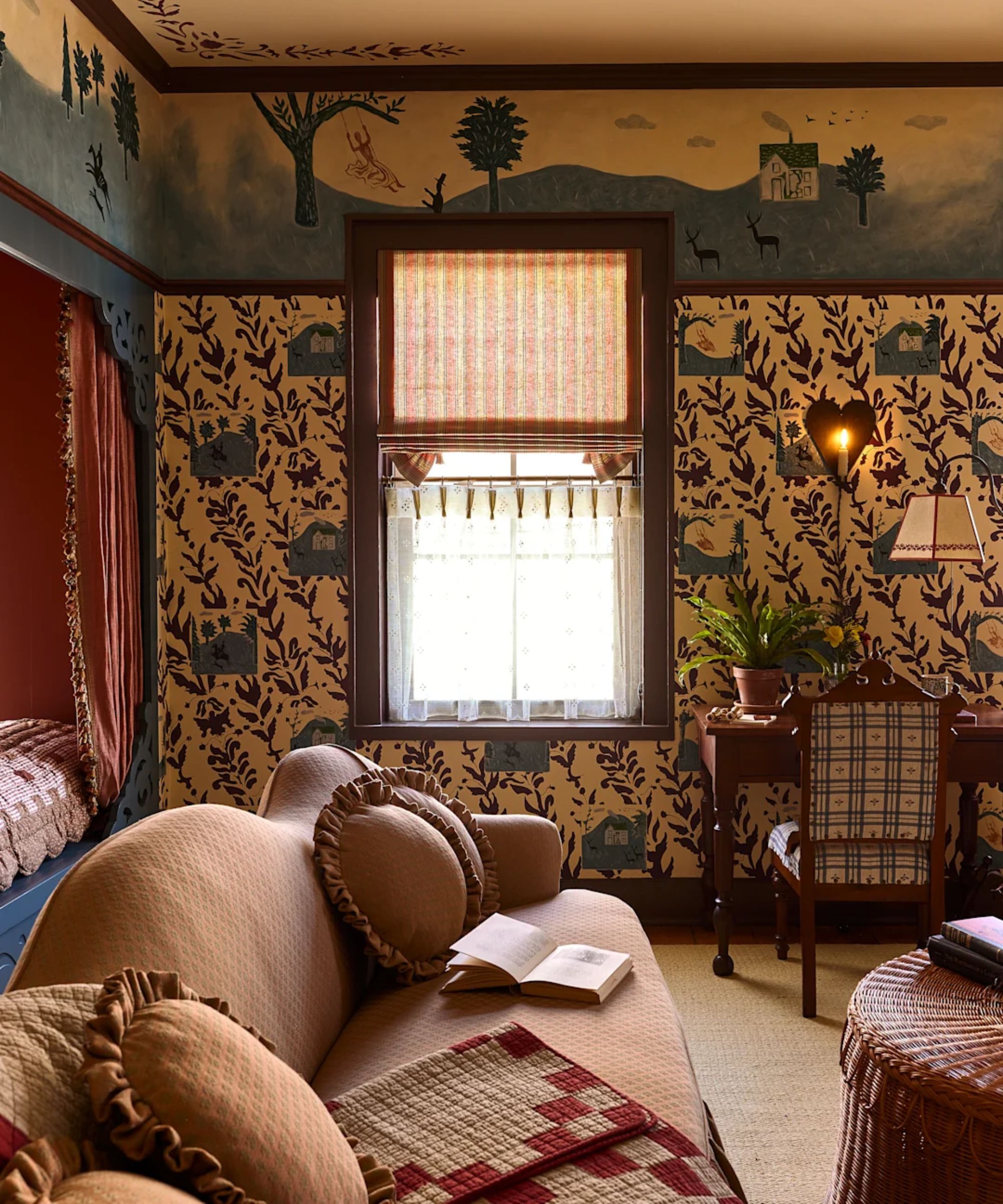 hotel bedroom at the six bells inn with floral style painted mural, wallpaper, a nook bed, and a large upholstered couch
