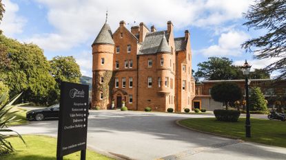 A front view of the brick facade of Fonab Castle in Scotland