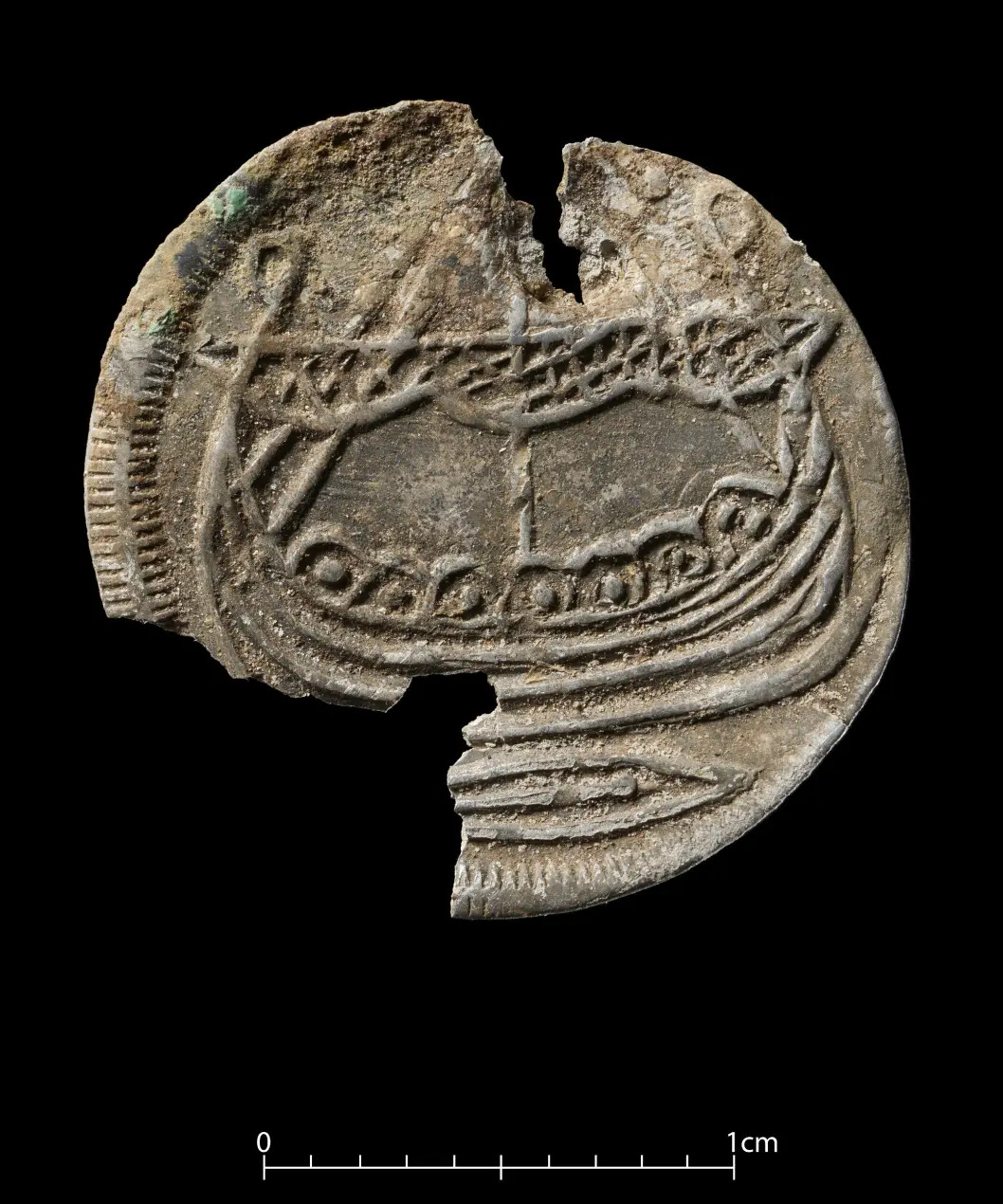 Coin with a boat carving found at burial spot.