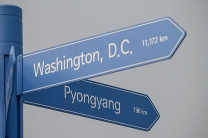 A signpost showing the directions and distances from Seoul to Washington and Pyongyang.