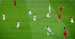 Players of Real Madrid celebrate as the final whistle is blown to confirm them as winners of the UEFA Champions League following victory in the UEFA Champions League final match between Liverpool FC and Real Madrid at Stade de France on May 28, 2022 in Paris, France.