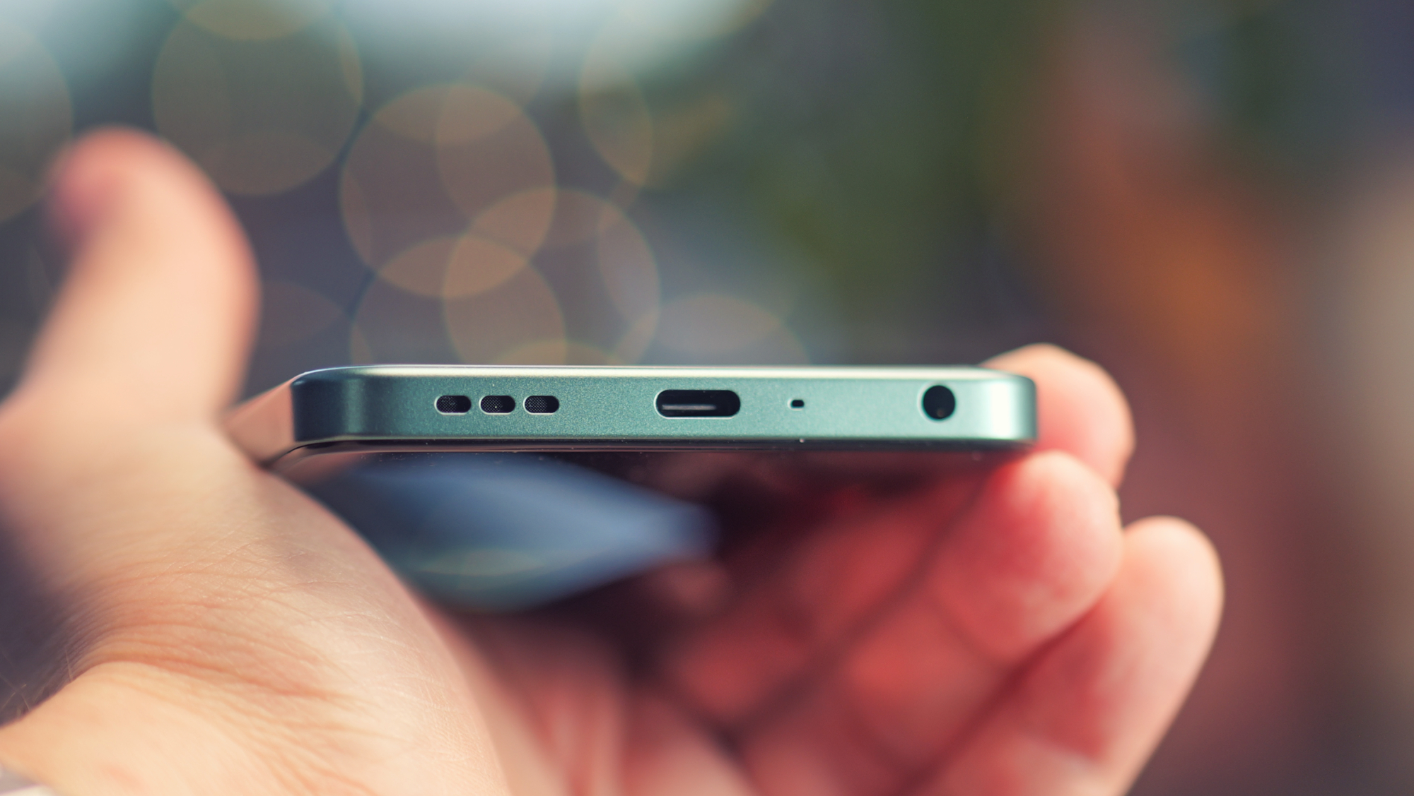 Oppo A5 5G phone held in a hand