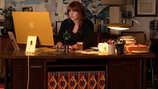 Bryce Dallas Howard working hard at her cluttered desk in Argylle.