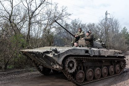 Ukrainian soldiers driving a tank. 