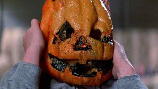 A child holding his pumpkin mask in Halloween III: Season of the Witch