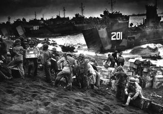 This squad of Marines, 2nd Separate Engineer Battalion, Co. B, unloads supplies on Red Beach, Iwo Jima