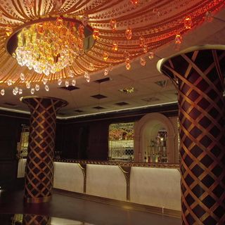 bar with giant chandelier and round pillar