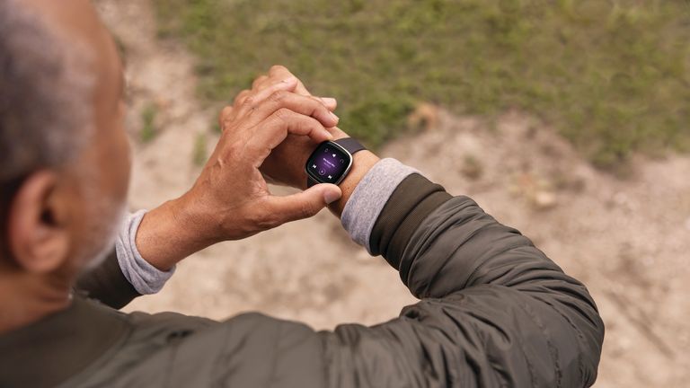 Man wearing the Fitbit Sense smartwatch