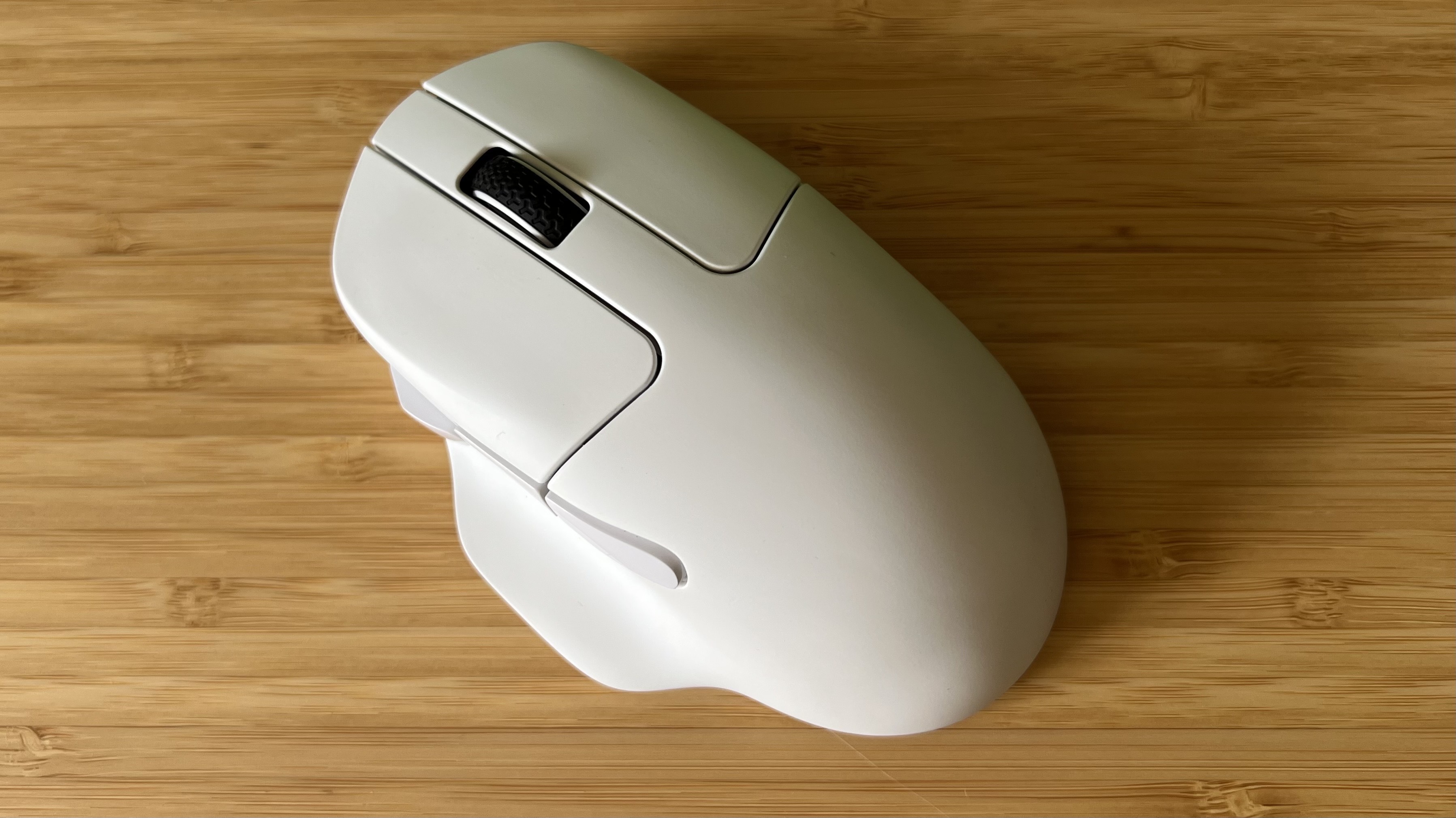 Keychron M7 8K gaming mouse on a wooden desk shown from above