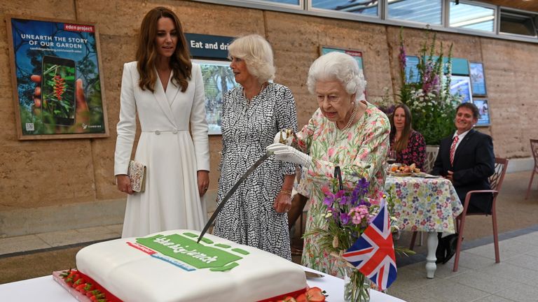 st austell, england june 11 queen elizabeth ii c attempts to cut a cake with a sword, lent to her by the lord lieutenant of cornwall, edward bolitho, to celebrate of the big lunch initiative at the eden project during the g7 summit on june 11, 2021 in st austell, cornwall, england uk prime minister, boris johnson, hosts leaders from the usa, japan, germany, france, italy and canada at the g7 summit this year the uk has invited india, south africa, and south korea to attend the leaders' summit as guest countries as well as the eu photo by oli scarff wpa pool getty images