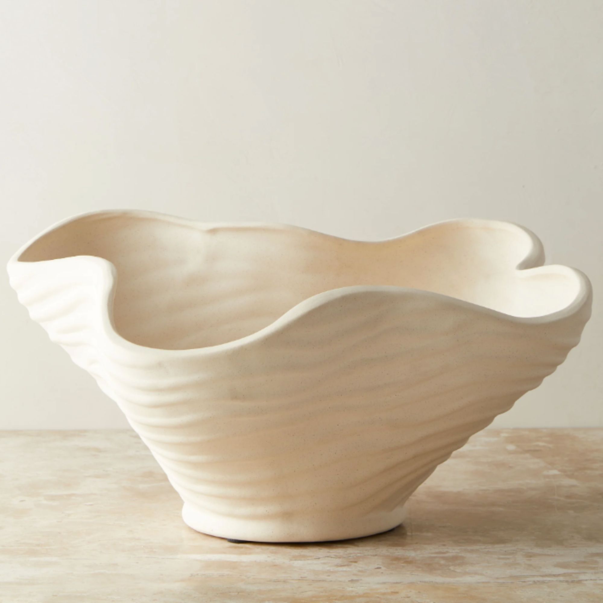 Wrinkled wavy ceramic bowl in sand color