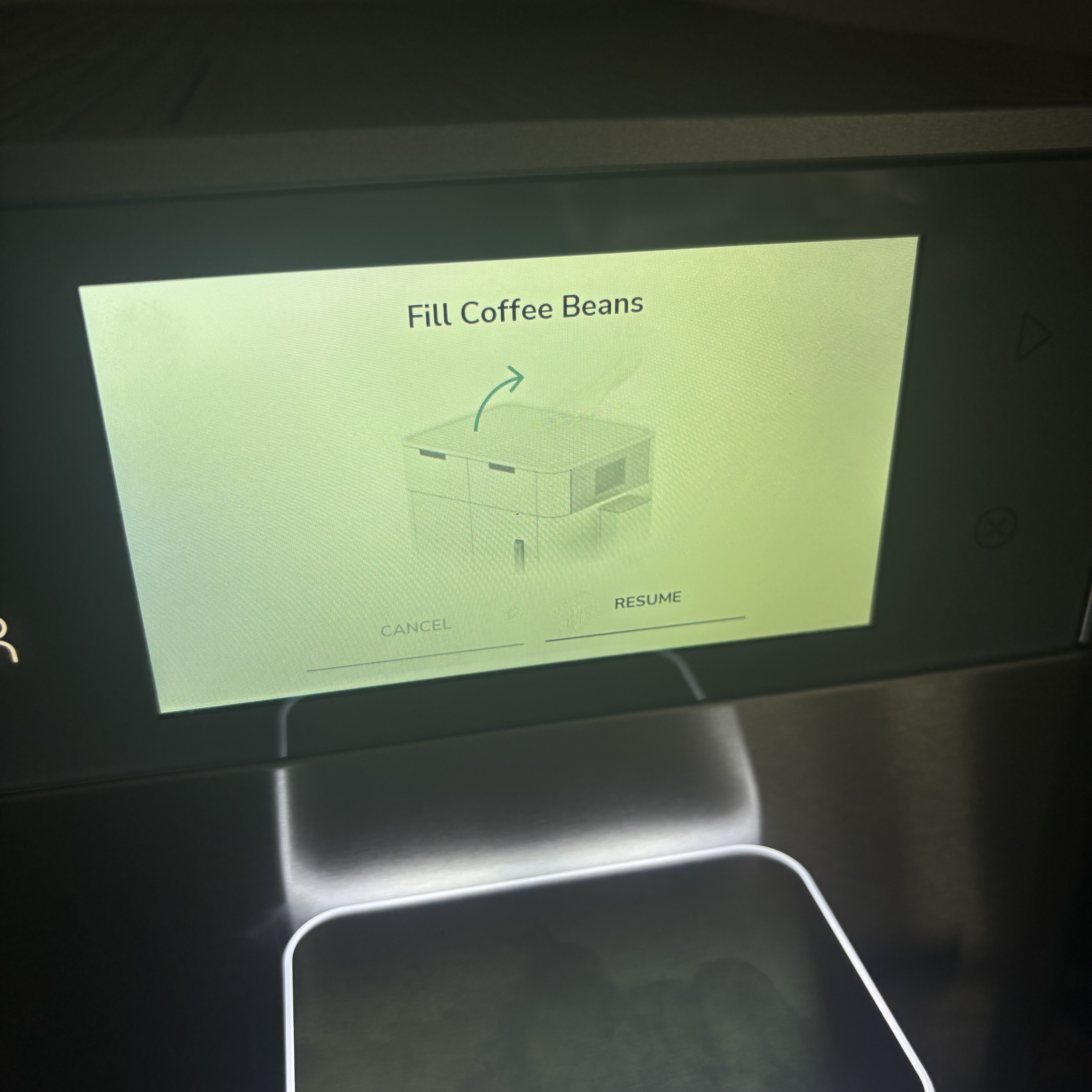 An onscreen reminder from the KitchenAid Fully Automatic Espresso Machine KF8.