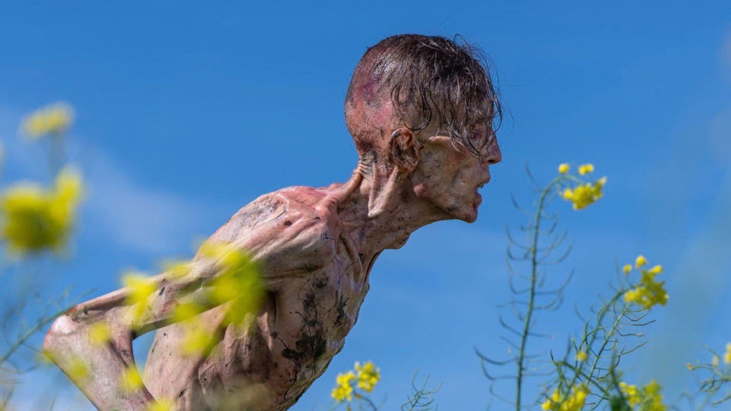 A still from 28 Years Later showing an infected man against blue sky