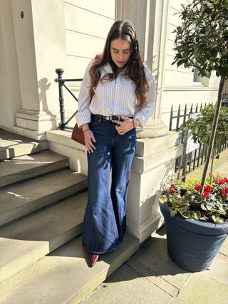 An image ofBest Knockoff Luxury Clothing
 SEO Writer Ava Gilchrist wearing one of the best flared jeans.