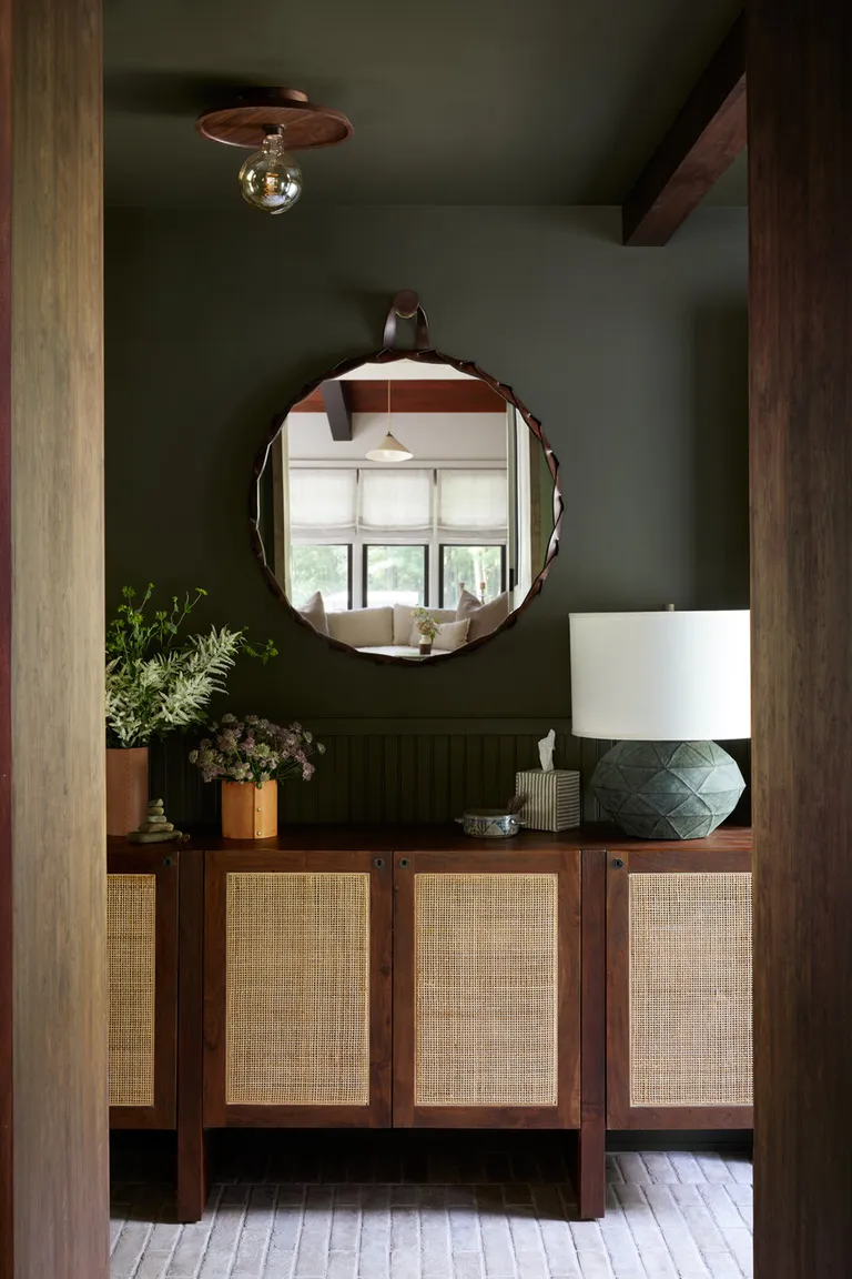 a small entryway with a mirror