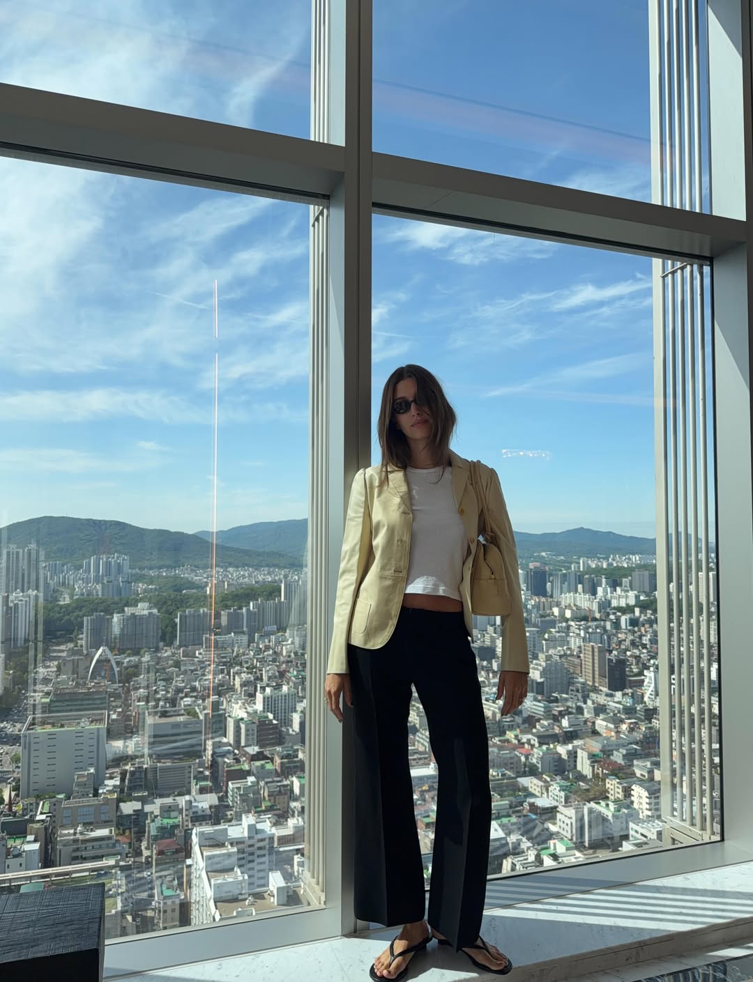 Hailey Bieber's Seoul Style Includes Two Chanel Bags, a Sheer Crochet Top, and Her Favorite Heeled Flip-Flops
