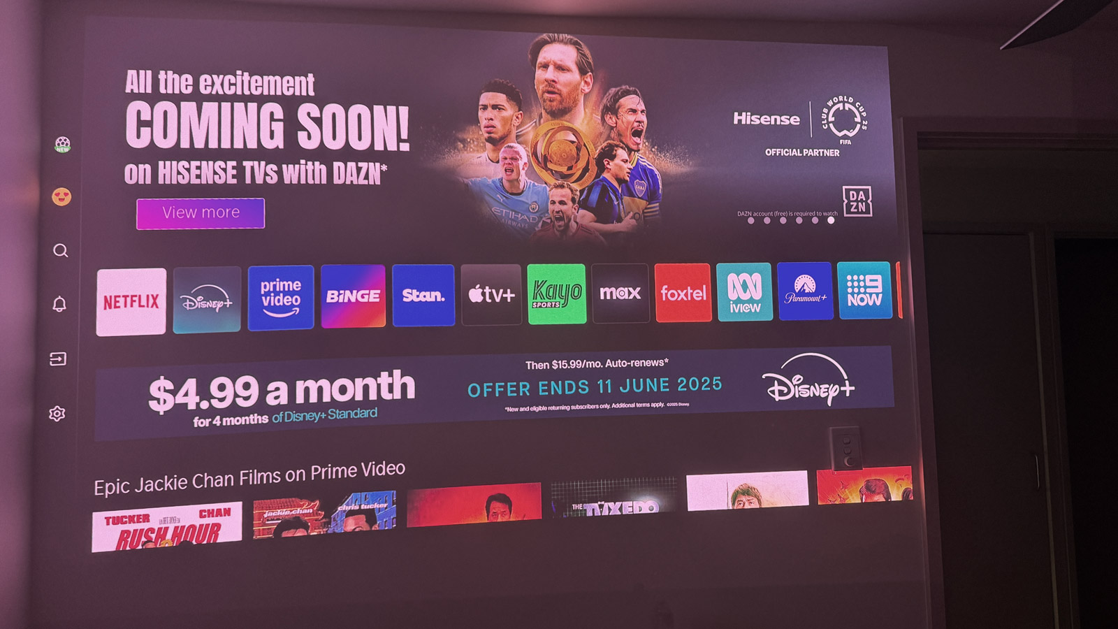 The Vidaa OS home screen of the Hisense C2 Ultra projected onto a wall.