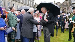 King Charles III greets during a Garden Party at the Palace of Holyroodhouse