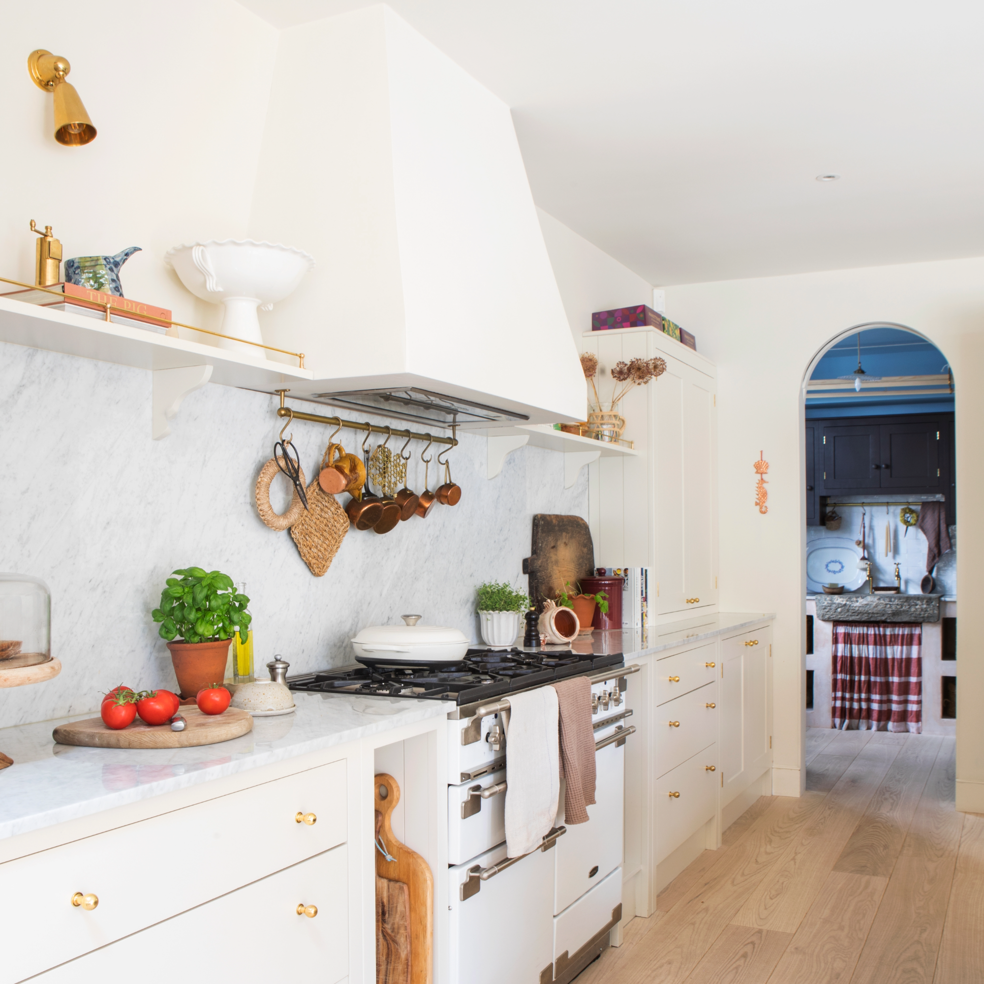 Le Creuset pan on white aga in marble and white kitchen