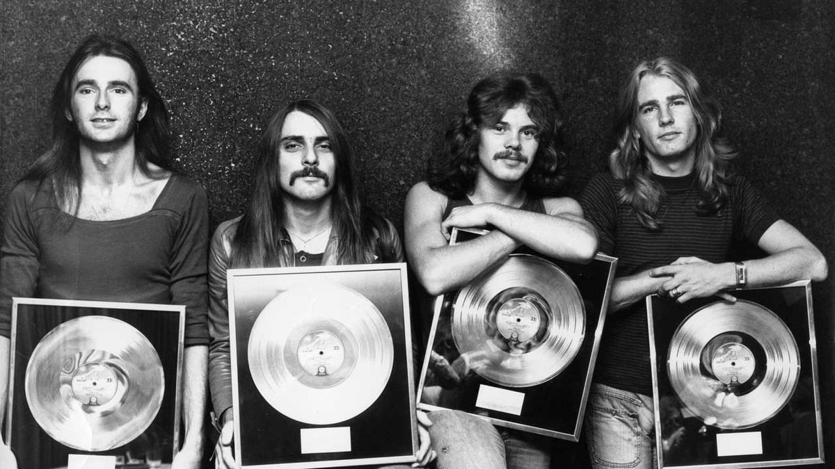 Status Quo holding gold discs