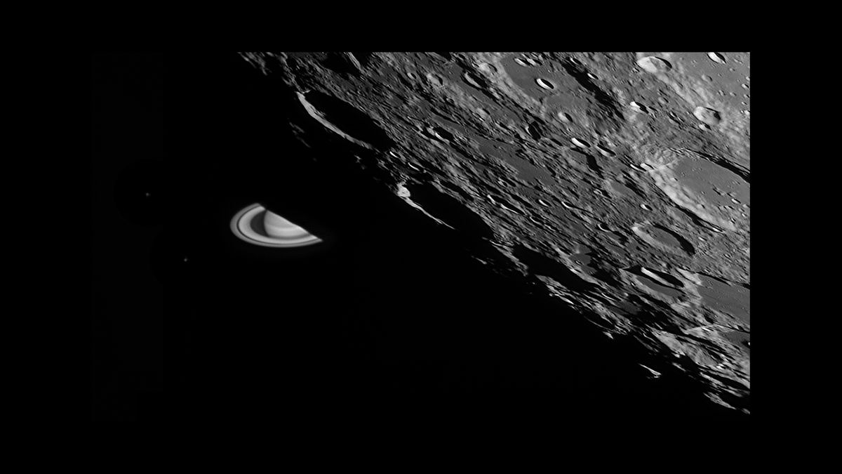 On August 12, 2019, our moon occluded Saturn and its moons. The shadowed limb of the waxing gibbous Moon gradually hid the planet over several minutes. Shadowed mountains are visible against the bright planet and rings as an irregular edge where the planet is hidden. To Saturn's left are two of its own icy moons, Tethys (lower) and Dione (upper), tiny specks in the darkness.
