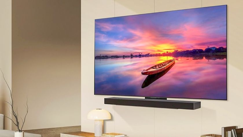 The LG C4 OLED TV mounted on a wall, displaying a high-resolution image of a small boat in front of a pink-and-blue sunset