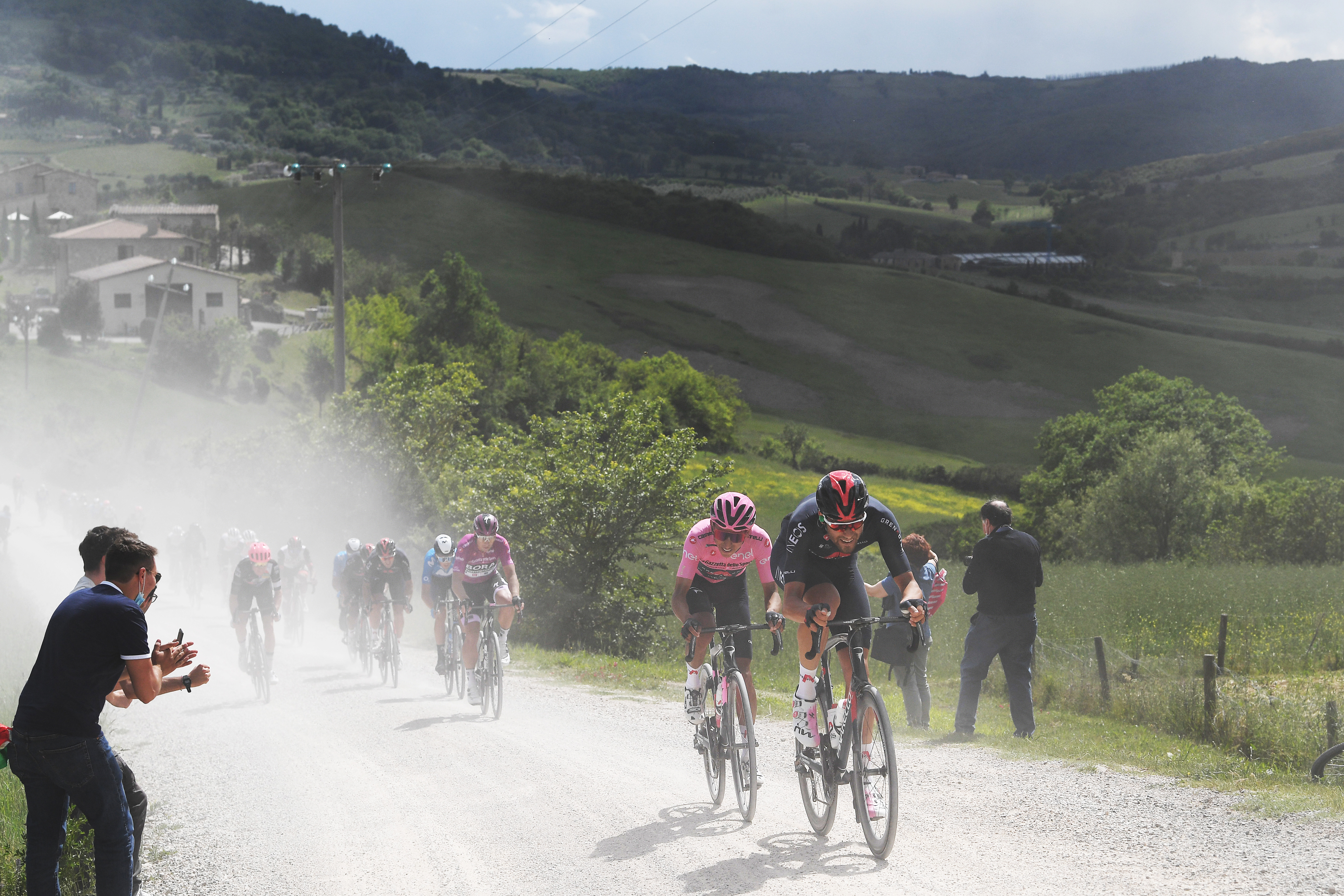 MONTALCINO, ITALY - MAY 19: Egan Arley Bernal Gomez of Colombia Pink Leader Jersey &amp;amp; Filippo Ganna of Italy and Team INEOS Grenadiers passing through a gravel strokes sector during the 104th Giro d&amp;amp;apos;Italia 2021, Stage 12 a 162km stage from Perugia to Montalcino 554m / Fans / Public / Dust / @girodiitalia / #UCIworldtour / #Giro / on May 19, 2021 in Montalcino, Italy. (Photo by Tim de Waele/Getty Images)