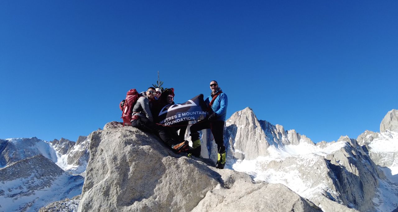 Ed and Lois Jackson, Ross Stirling and guide Kurt Wedberg with their Christmas tree on the summit of Thor Peak