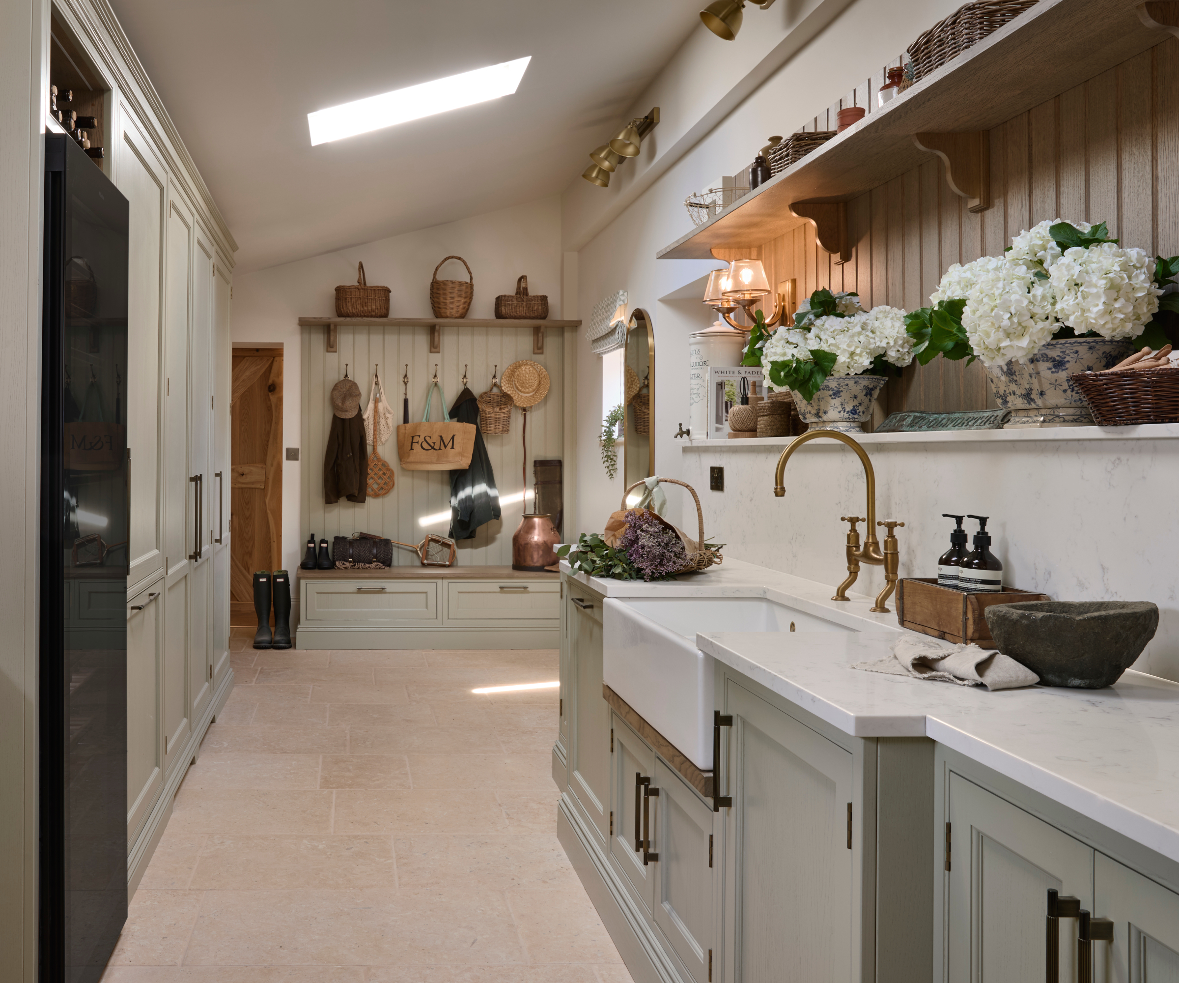 galley kitchen with tall cabinets on one side, base units and shelving on the other side