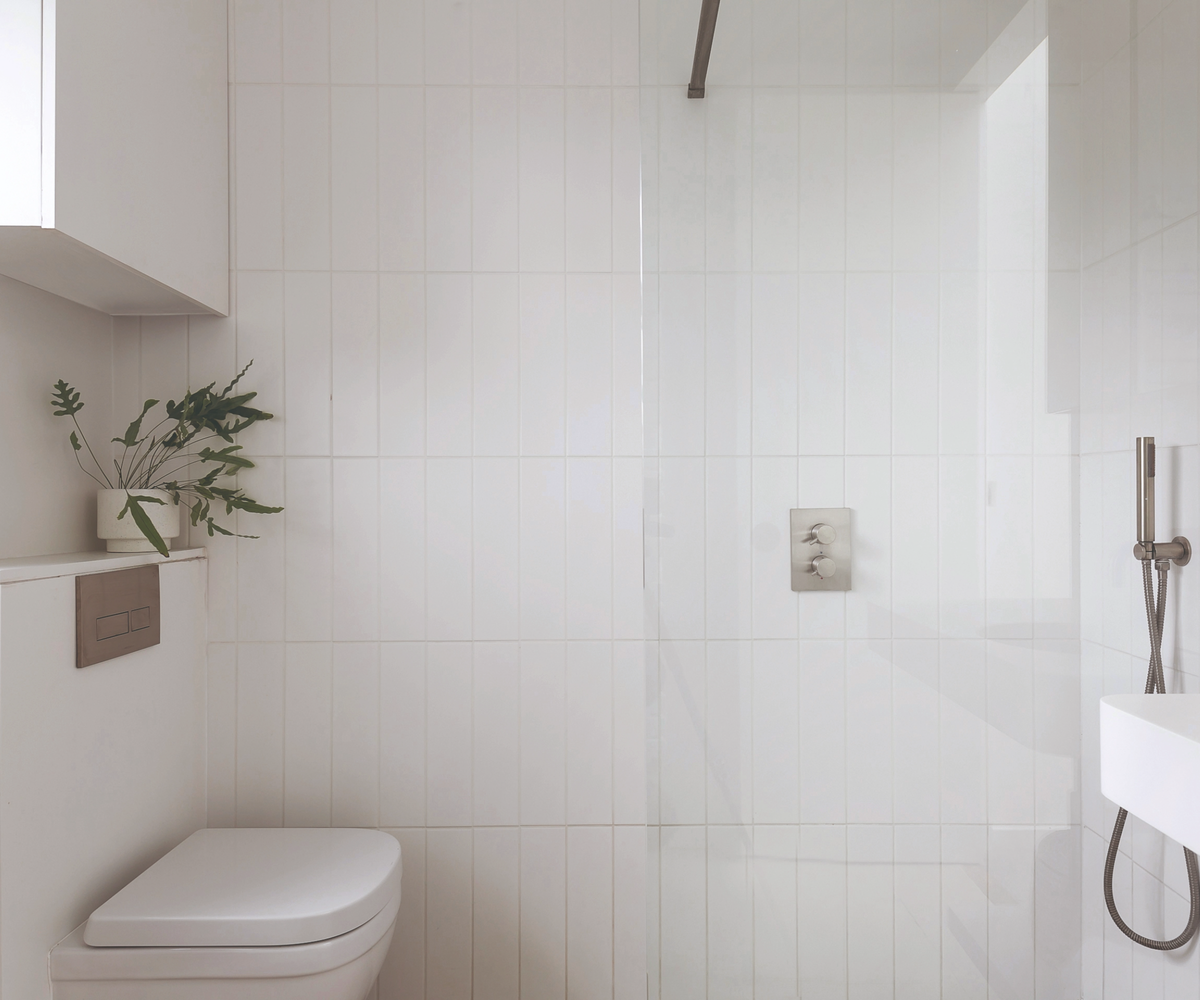 Bathroom facing the shower and toilet and sink