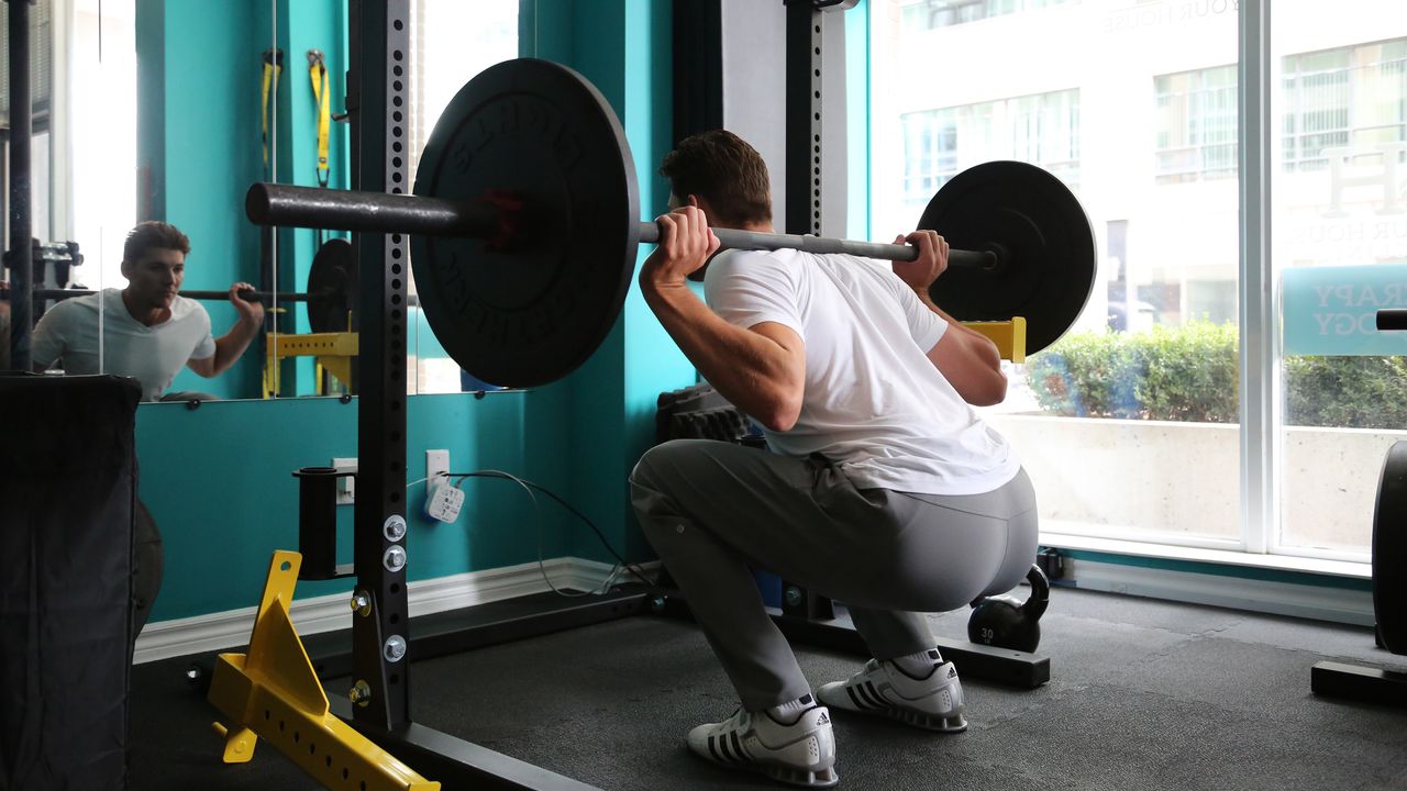 Man doing barbell squat