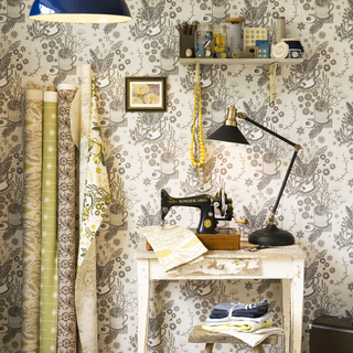 sewing room with wallpaper and sewing machine
