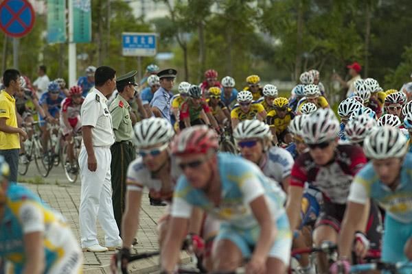 The peloton corner as members of the Chinese forces look on during stage two.