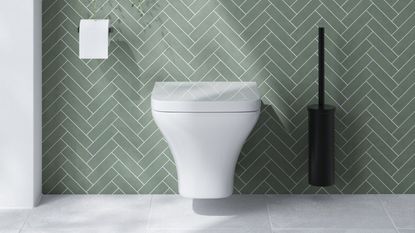 A toilet mounted on a bathroom wall with mint green tiles