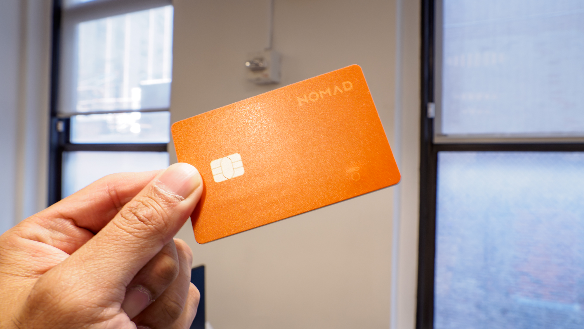 Nomad Tracking Card Pro held in the hand.