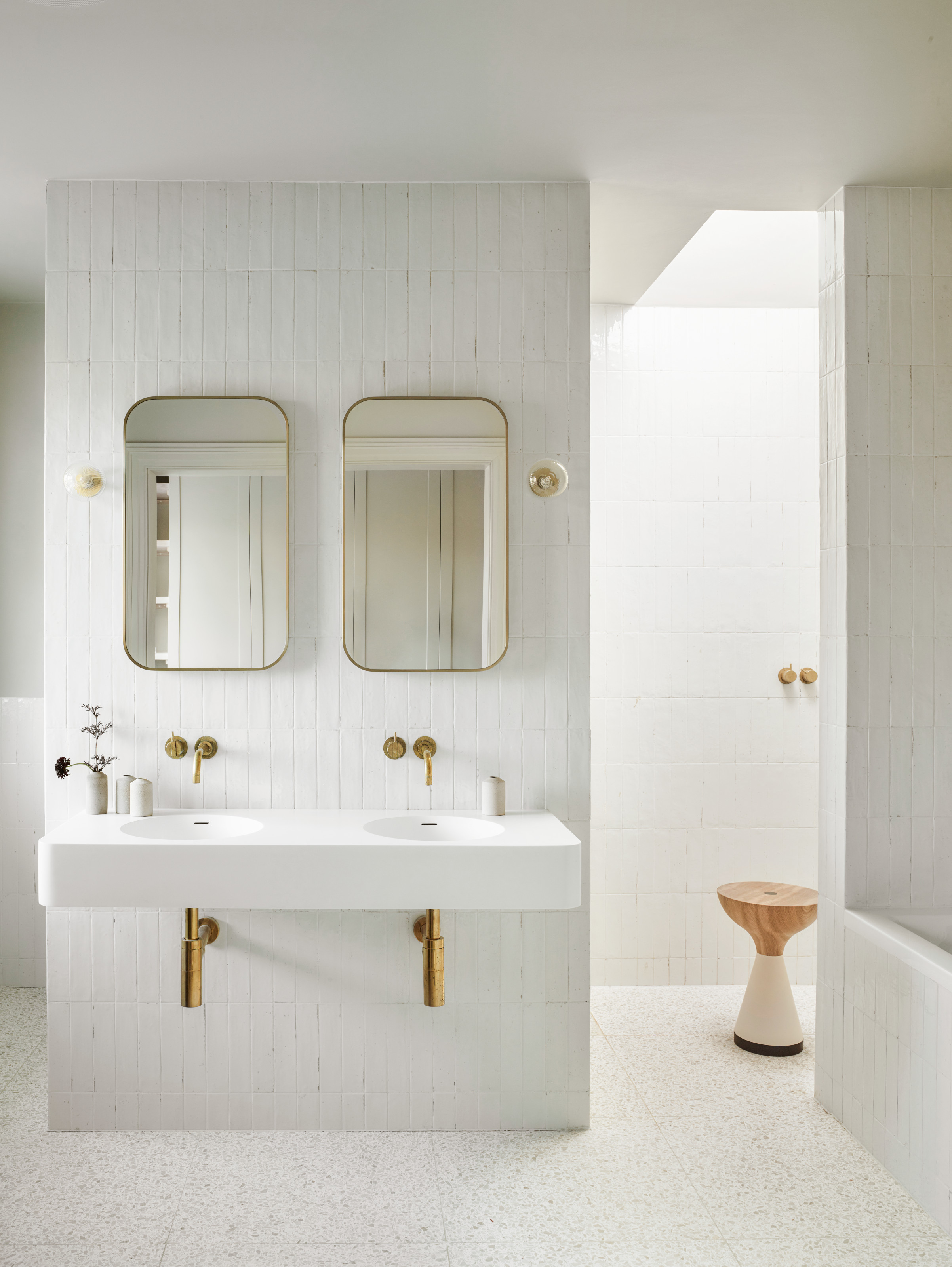White bathroom with twin sink and double mirrors