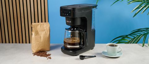 A black Instant Infusion Brew 12-Cup drip coffee maker with a removable water reservoir, glass carafe and reusable coffee filter