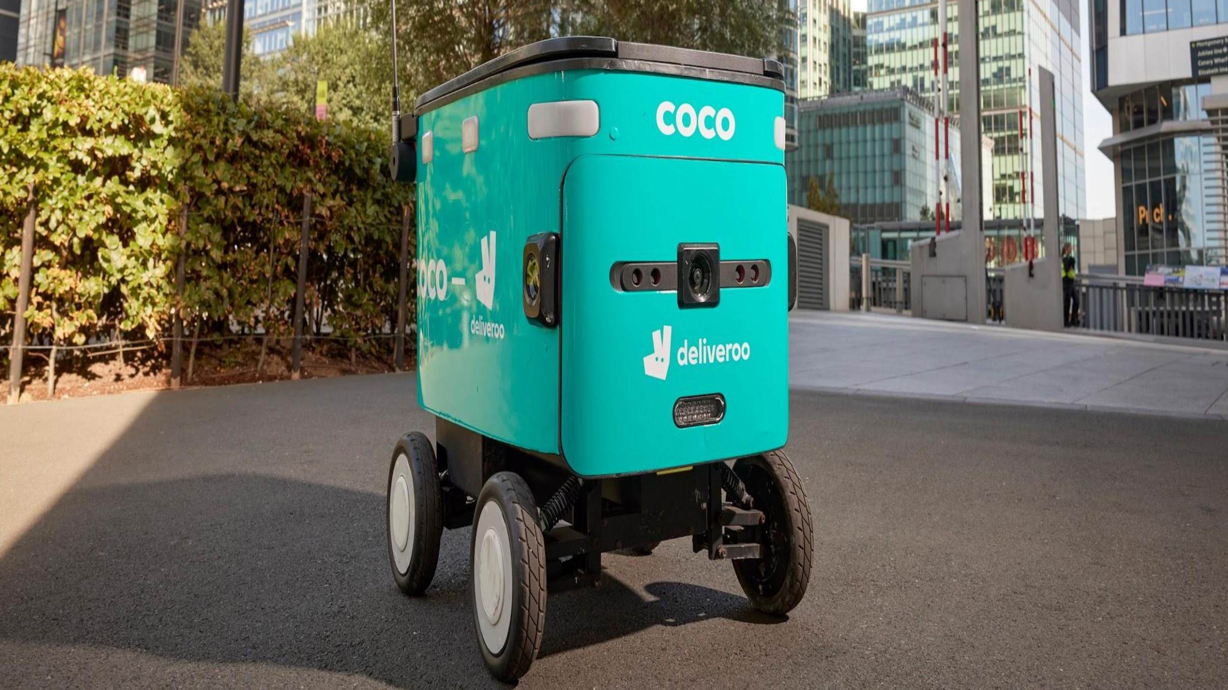 A Deliveroo delivery robot standing on a path