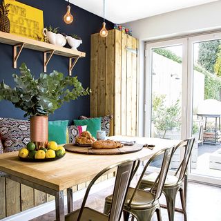 dining area with dark blue wall and sliding door
