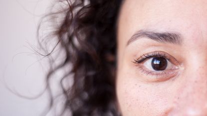 A closeup of a woman's face, highlighting one eye.