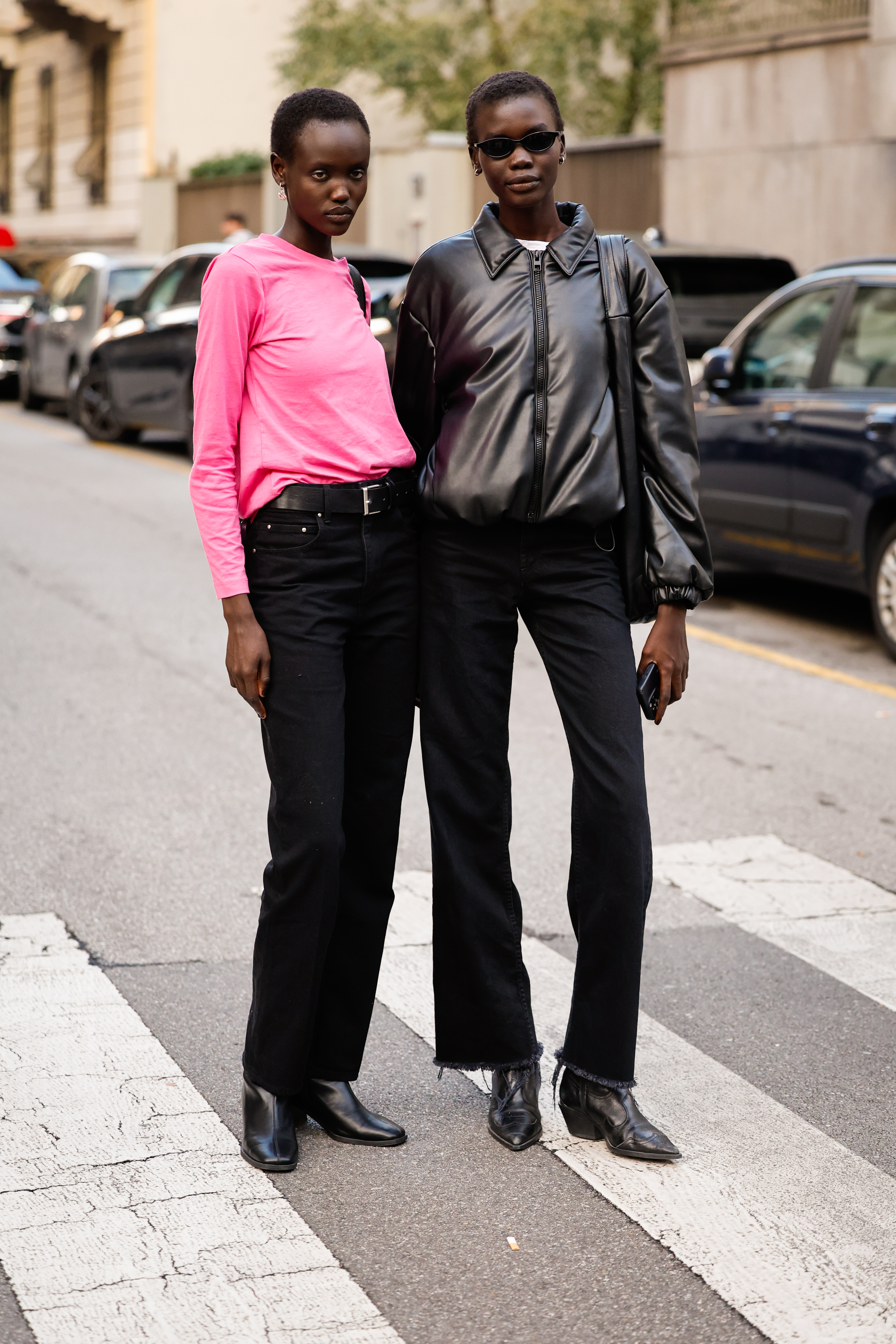 A woman wears frayed-hem jeans with a leather jacket and boots.