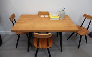 Wooden dining table and chairs with black legs