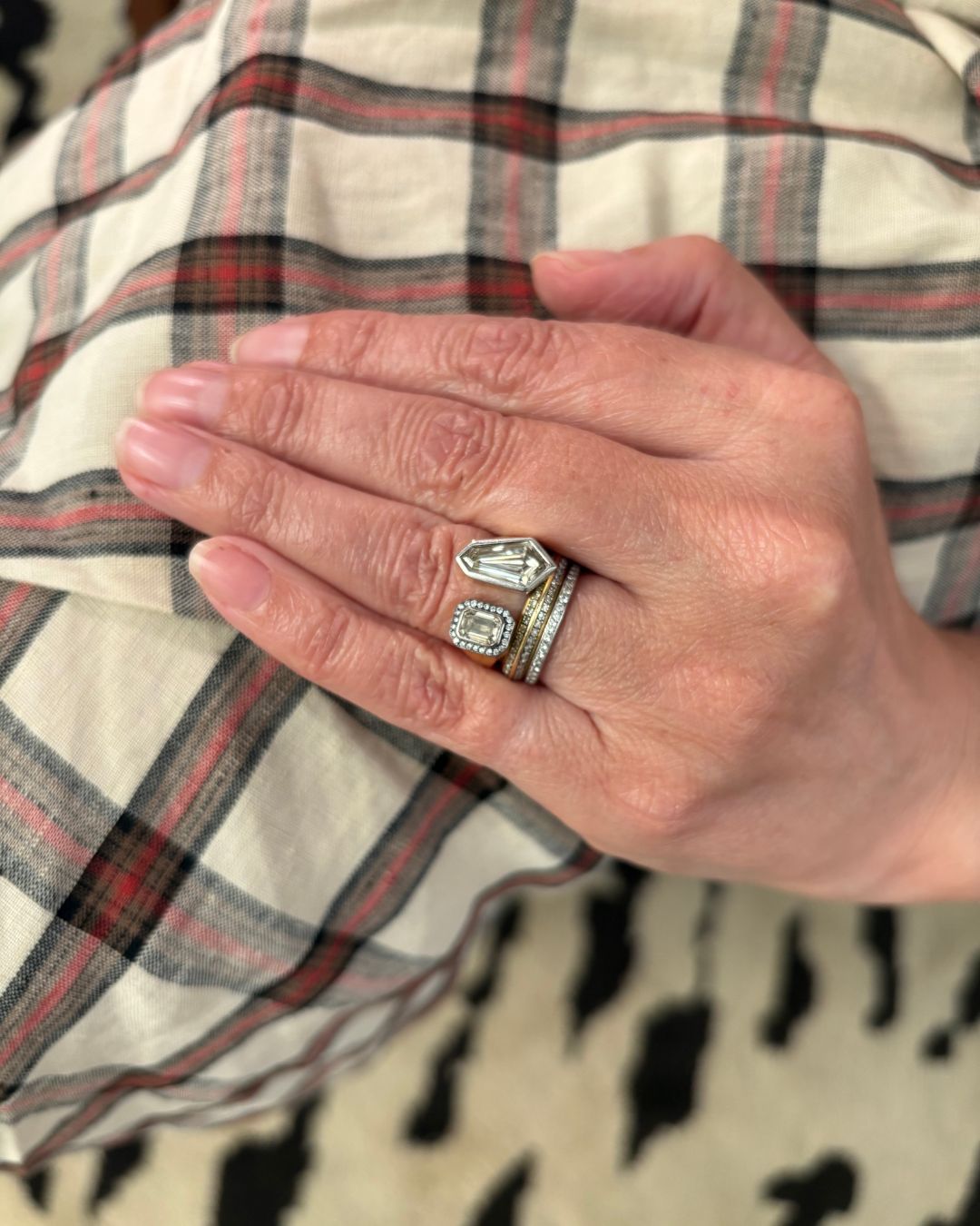 a photo of lucy delius' engagement ring and wedding bands