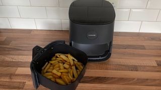 The Cosori Pro LE Air Fryer L501 with the frying basket containing fries removed