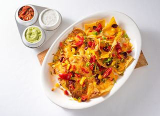 A bowl of nachos and dips