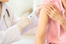 A healthcare worker giving someone a vaccine.