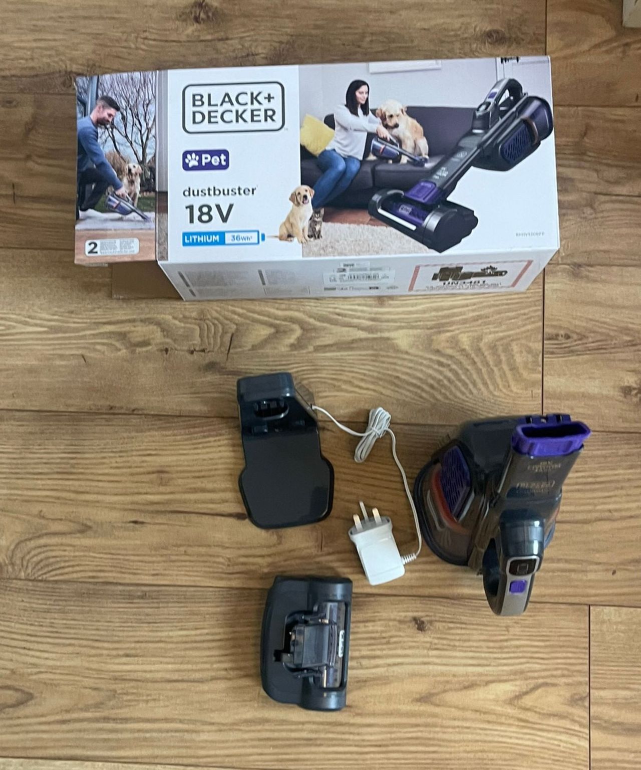 Black+Decker dustbuster furbuster AdvanceClean+ Pet handheld vacuum parts, attachments and original packaging on wooden floor