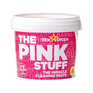 A pink plastic container with 'The Pink Stuff' branding across the front. 