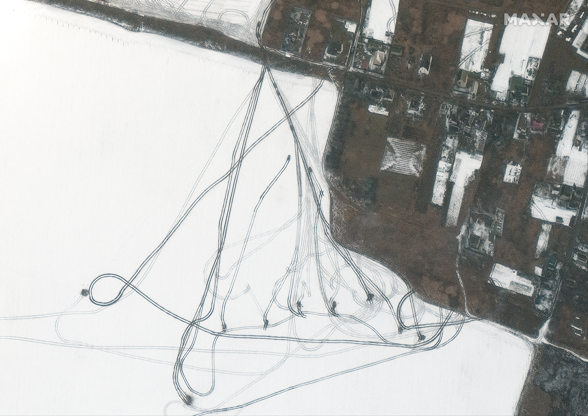 Armored vehicles move across snowy terrain northeast of the Antonov Airport in Hostomel, Ukraine in this view taken on March 8, 2022 by Maxar Technologies' WorldView 3 satellite.