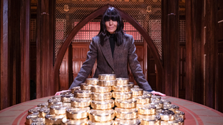 Claudia Winkleman over-seeing the a pile of gold coins